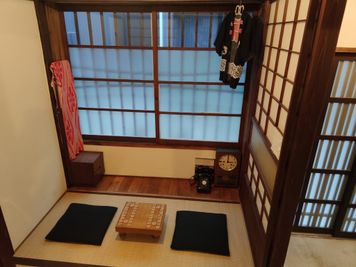 一階：和室。ちゃぶ台の代わりに将棋盤（オプション）を配置。窓を開ければ換気も可能で、道行く人を眺めながら対局をお楽しみ頂けます。 - 月島長屋 多目的スペースの室内の写真