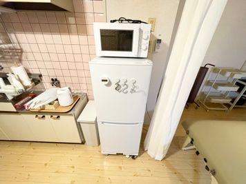 電子レンジ、冷蔵庫（上が冷蔵庫、下が冷凍庫）、ゴミ箱（※施術や掃除等で出たゴミのみお入れください） - 広島レンタルサロンBuddy 完全個室レンタルサロンの設備の写真
