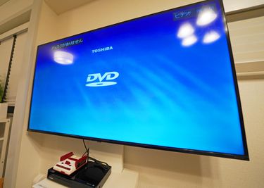 50インチTVはHDMIでPCとも接続OK、
DVDプレーヤとゲーム機もあります - つくばレンタルスペース パークサイド二の宮 レイアウト自在！食事会・サロン・会議に！32㎡のレンタルスペースの室内の写真