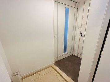 【玄関】
白を基調とした明るい玄関でお出迎え♫
※傘立て、靴べらあり。
(右側の扉はトイレになります) - Ｋ'sプロ銀座院 【24h利用OK】駅近13階の完全予約制プライベートサロン♫の入口の写真